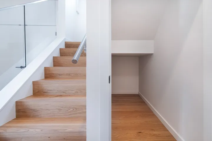 Stairway featuring wood finished floors and baseboards