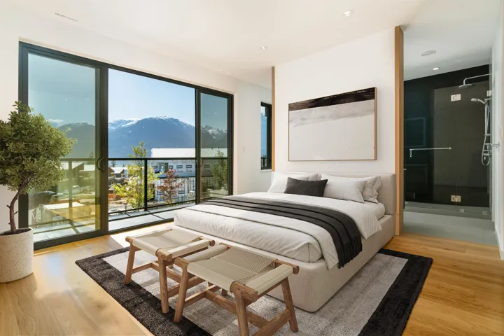 Bedroom featuring light wood finished floors, a mountain view, and access to exterior