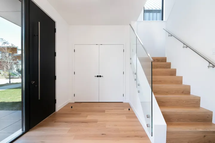 Staircase featuring wood finished floors and a healthy amount of sunlight