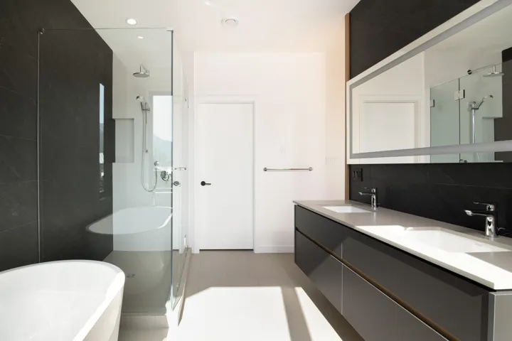Bathroom featuring a freestanding bath, tile patterned flooring, a stall shower, and a sink