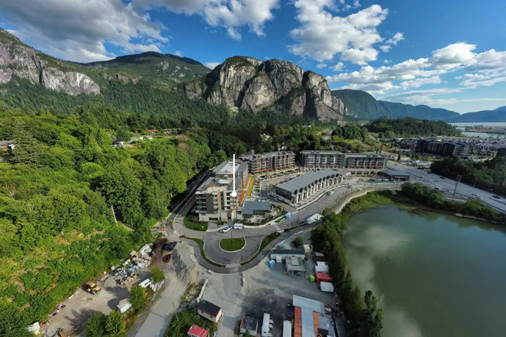 View of property location with a water and mountain view and a forest