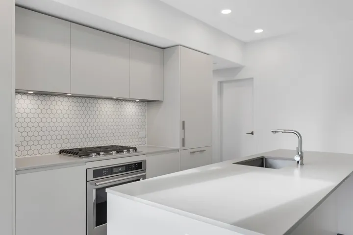 Kitchen with appliances with stainless steel finishes, light countertops, tasteful backsplash, recessed lighting, and modern cabinets