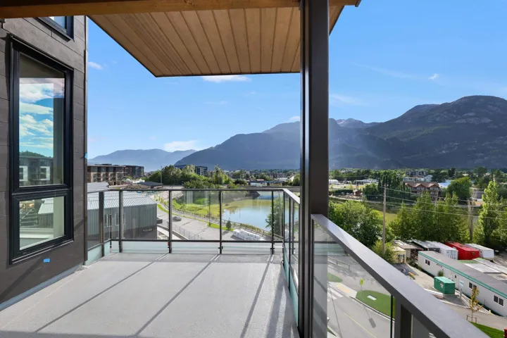 Balcony featuring a water and mountain view