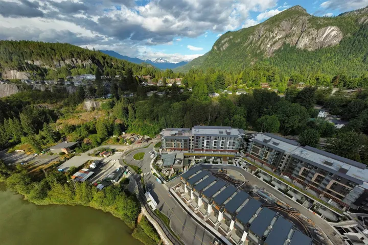 Aerial overview of property's location featuring mountains and a forest