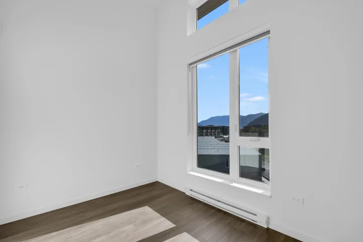 Spare room with a baseboard heating unit, dark wood-style floors, and a mountain view