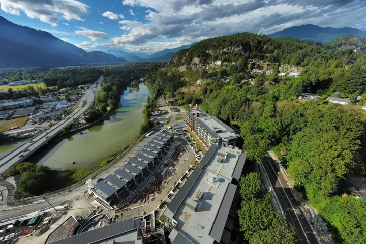Aerial view of property's location with a water and mountain view and a forest