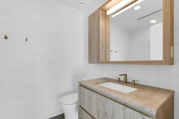 Bathroom featuring tile walls and vanity