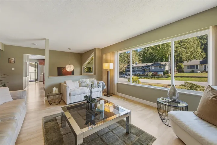 Living room with light wood-style floors and a textured ceiling