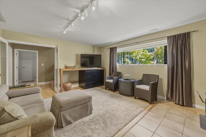 Living area featuring rail lighting and light tile patterned floors