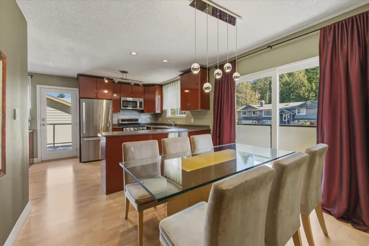 Dining space with light wood-style floors, a textured ceiling, and recessed lighting