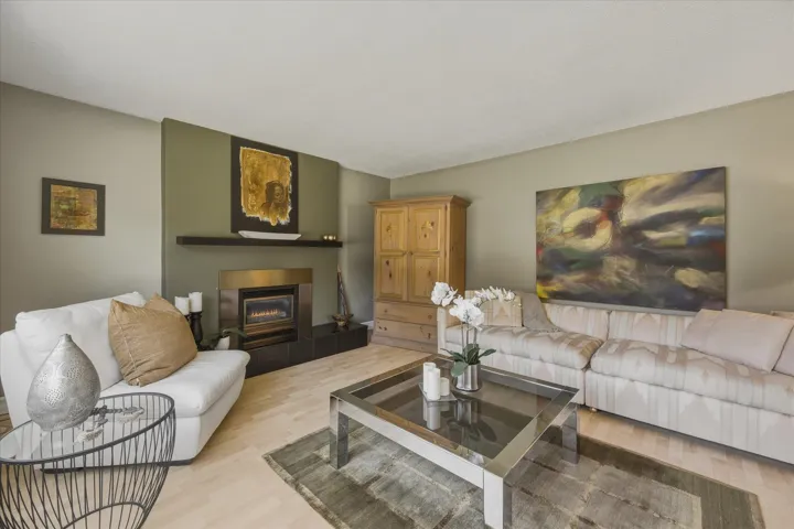 Living area featuring light wood finished floors and a tile fireplace