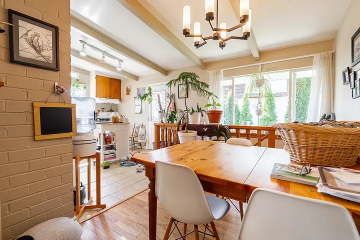 Dining room with beamed ceiling, a chandelier, and light wood-type flooring