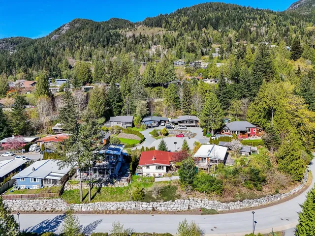 Aerial view featuring a forest view, a residential view, and a mountain view