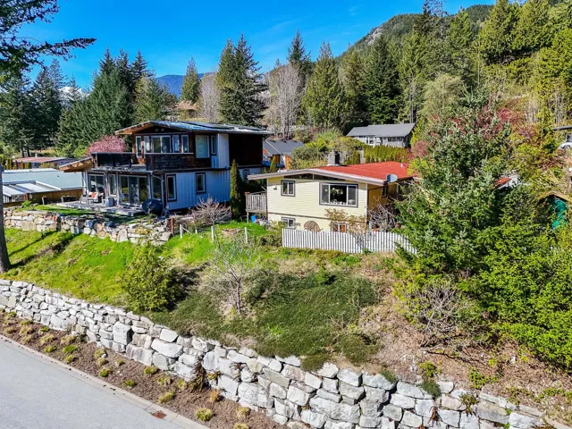 Rear view of property featuring a mountain view and fence