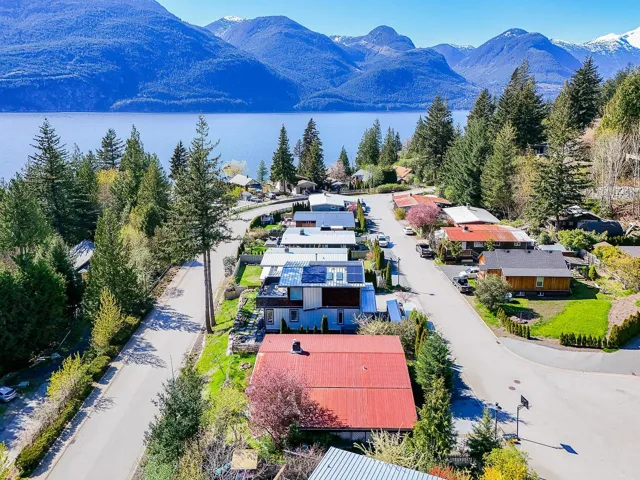 Birds eye view of property with a water and mountain view