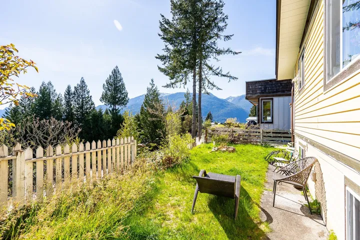 View of yard with a mountain view and fence