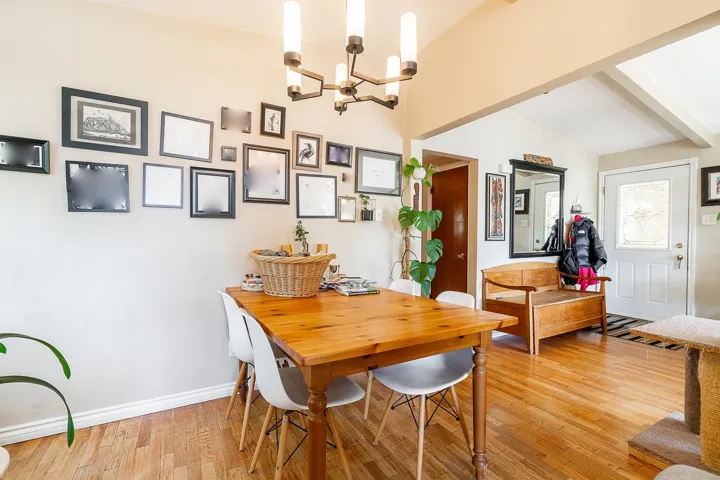 Dining space featuring baseboards, an inviting chandelier, light wood-style flooring, and beam ceiling