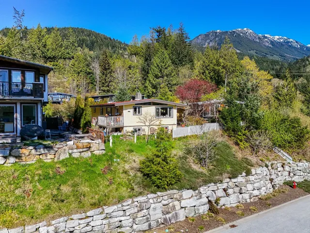 Exterior space with a wooded view and a deck with mountain view
