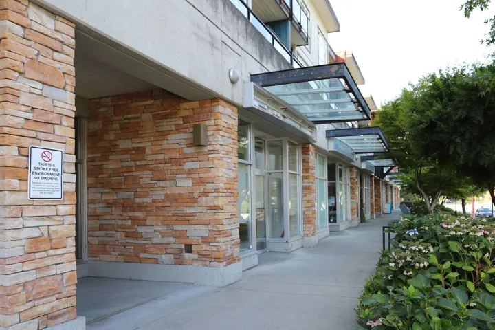 View of side of property featuring stone siding