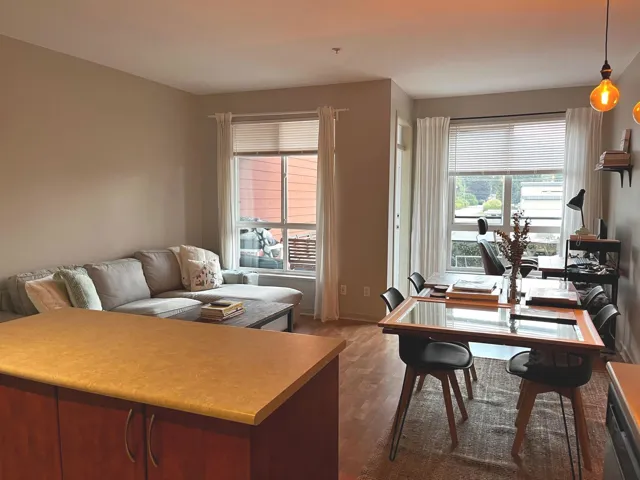 Home office with healthy amount of natural light and dark wood-type flooring