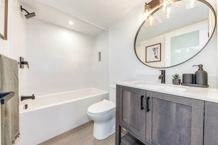 Bathroom featuring vanity, shower / bathtub combination, and recessed lighting