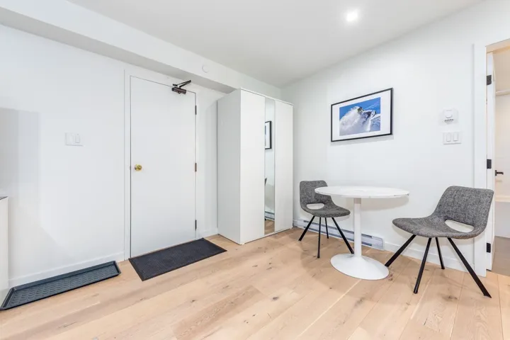 Foyer with light wood-type flooring and baseboard heating