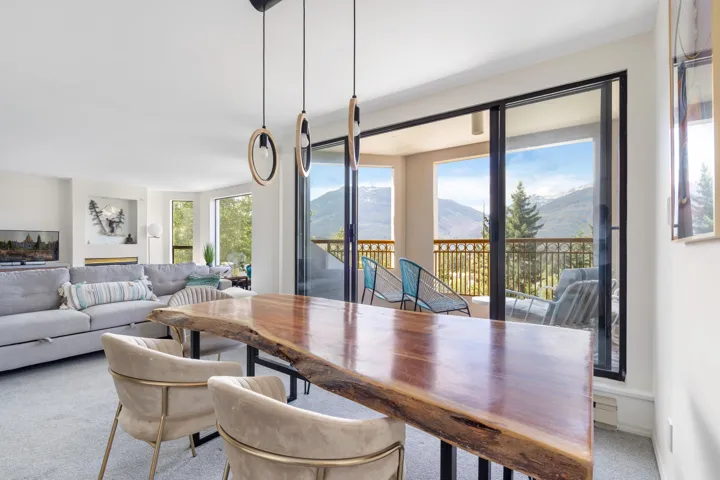 Dining room featuring a mountain view and light carpet