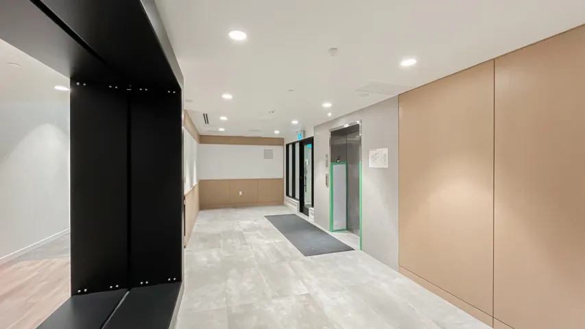 Hallway with elevator and recessed lighting