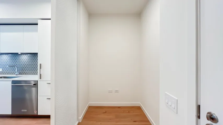 Hallway with light wood-style floors and a sink