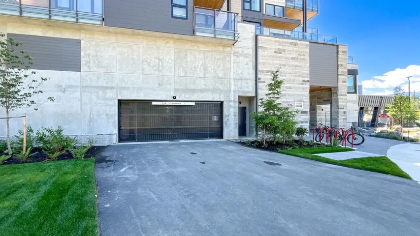 View of front of home with an attached garage and asphalt driveway
