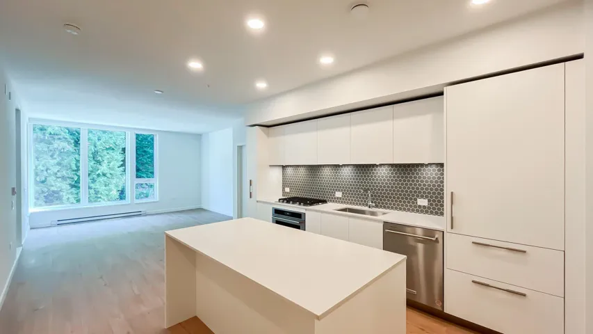 Kitchen with modern cabinets, backsplash, light wood finished floors, stainless steel appliances, and recessed lighting