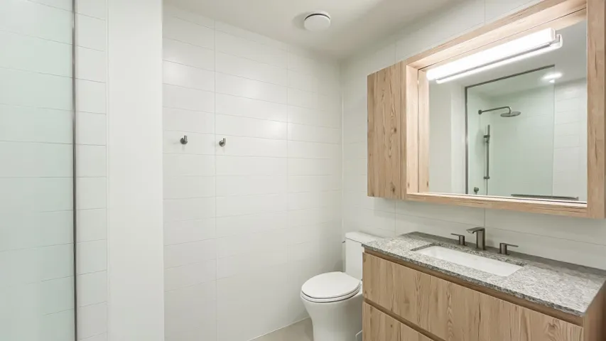 Bathroom with vanity and tile walls