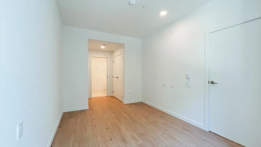 Empty room featuring light wood finished floors and baseboards