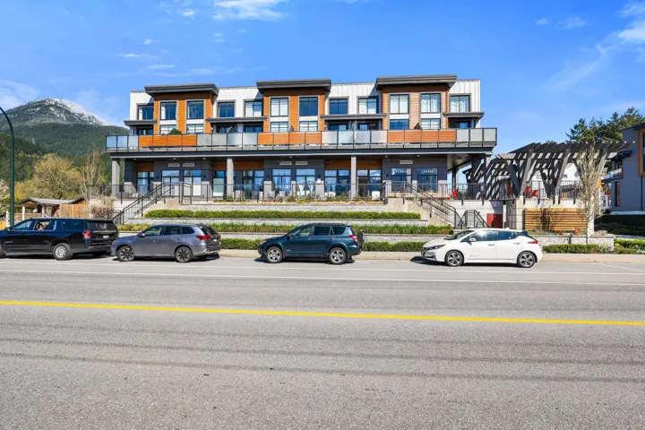 Multi-level building with contemporary architecture, featuring expansive windows and private balconies with glass railings