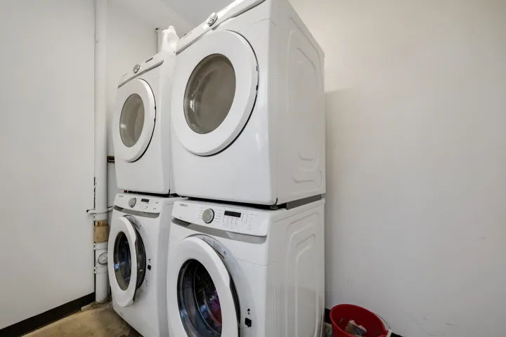 Stacked white front-loading washer and dryer units