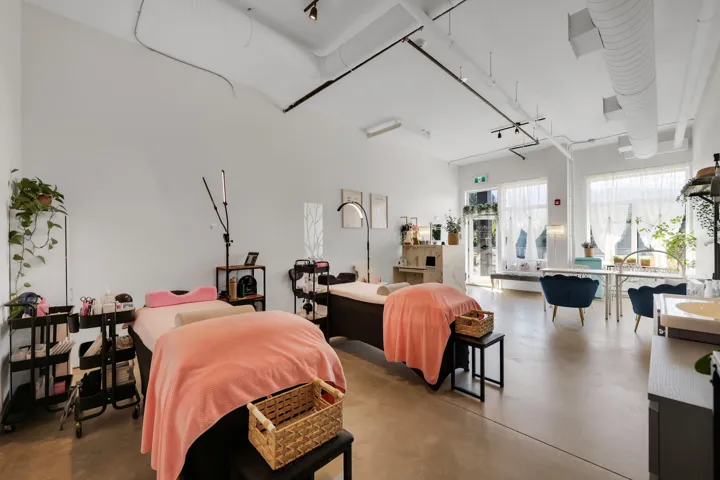 Open-concept commercial space featuring concrete flooring and exposed ductwork