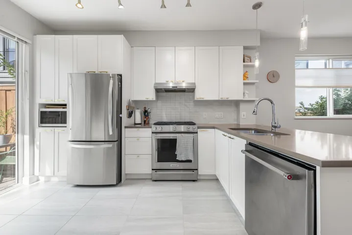 Kitchen featuring stainless steel appliances, open shelves, tasteful backsplash, white cabinets, and light tile patterned floors