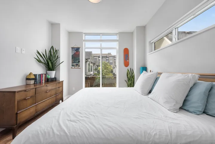 Bedroom featuring multiple windows and access to exterior