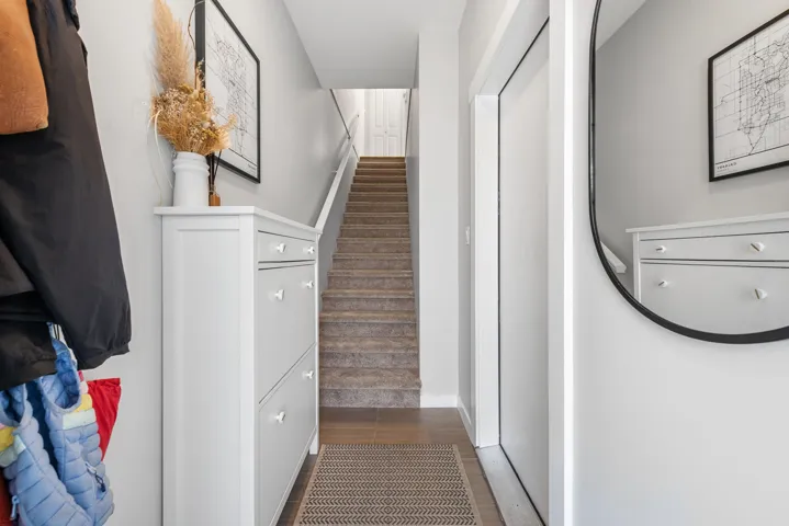 Stairway with wood finished floors and baseboards