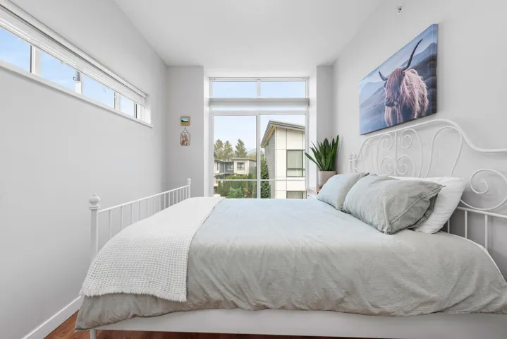 Bedroom with wood finished floors and baseboards