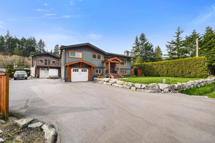 View of front of property featuring driveway, a garage, and the carriage house.