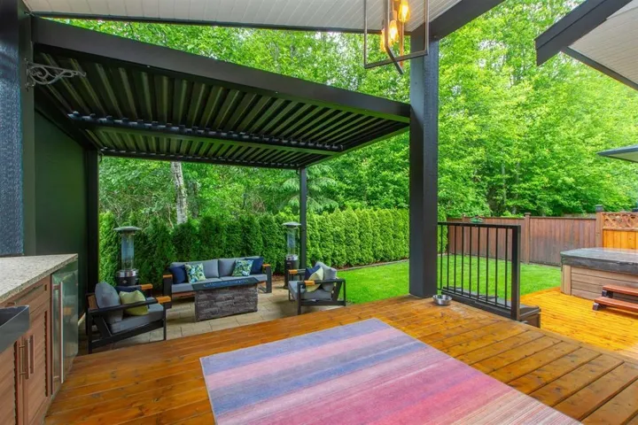 Deck featuring an outdoor hangout area and a fenced backyard
