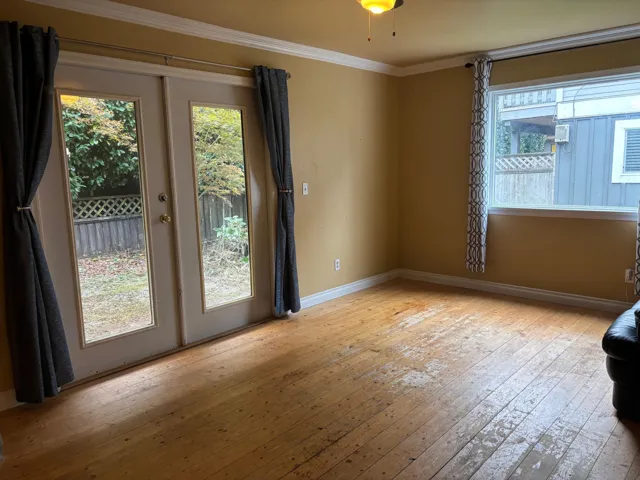 Spare room with light wood-style floors and crown molding