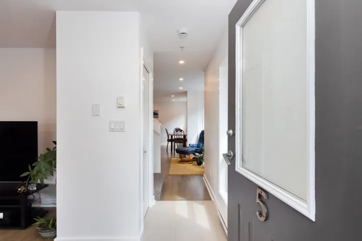 Hall featuring light tile patterned floors and recessed lighting