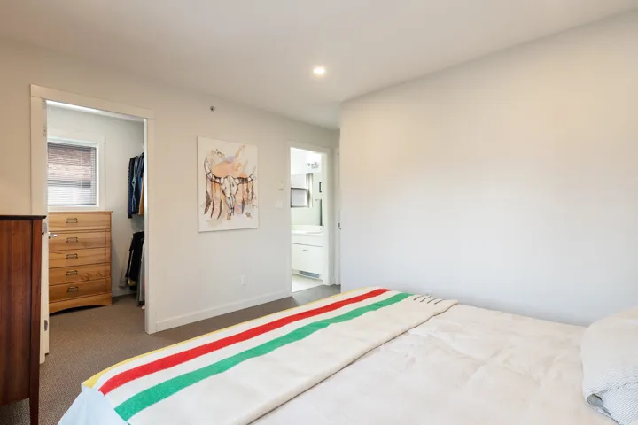 Carpeted bedroom with a closet, baseboards, a spacious closet, recessed lighting, and ensuite bath
