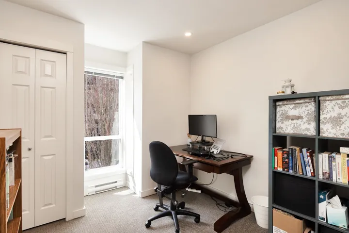 Office space featuring a baseboard radiator, baseboards, carpet, and recessed lighting