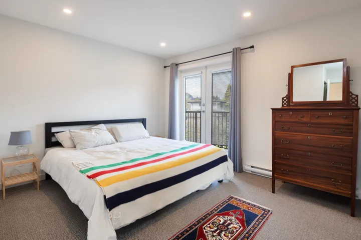 Carpeted bedroom featuring recessed lighting and baseboard heating