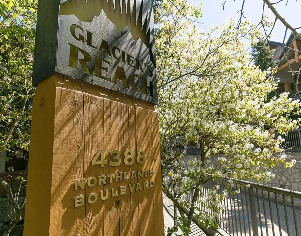 Wood-finish signpost featuring metal lettering