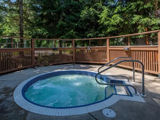 View of swimming pool with an in ground hot tub