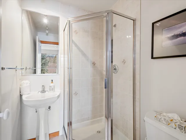 Full bathroom with a stall shower and toilet